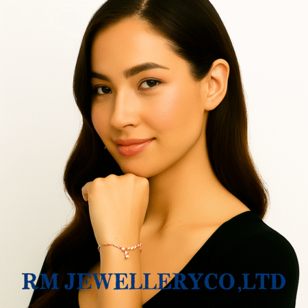 "Close-up of a woman modeling a delicate cord bracelet in a reddish hue (rose gold or red string) featuring a small, vertical, clear crystal charm or accent.