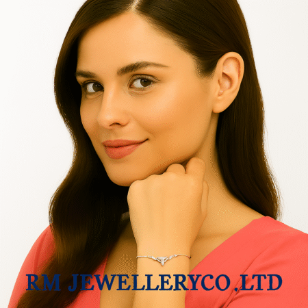 "Close-up of a woman wearing a delicate, silver-tone bracelet featuring a small, geometric or abstract crystal centerpiece, possibly shaped like a small bow or infinity symbol.