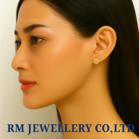 "Pair of small, gold-tone stud earrings in a four-leaf clover or quatrefoil shape, completely paved with clear, round crystals."